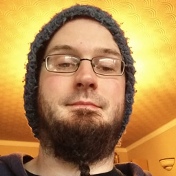 A picture of Chris - a man with glasses, a beard, and a silly wooly hat